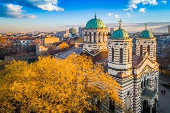 Amazing aerial drone shot of a church located in the heart of the city during sunset The scene is located in a public park in Sofia, Bulgaria (Eastern Europe). The picture is taken with DJI Phantom 4 Pro drone / quadcopter.